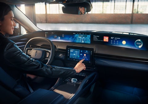 The driver of a 2024 Lincoln Nautilus® SUV interacts with the center touchscreen. | Allan Vigil Lincoln, Inc. in Morrow GA